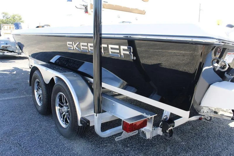 Slide: The Image of 2026 Skeeter SX241 boat on trailer, sleek black design, dual axle wheels. - 26