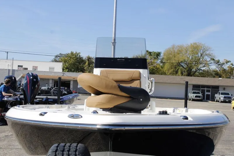 Slide: The Image of 2026 Skeeter SX241 boat with tan seating, displayed outdoors on a sunny day. - 4
