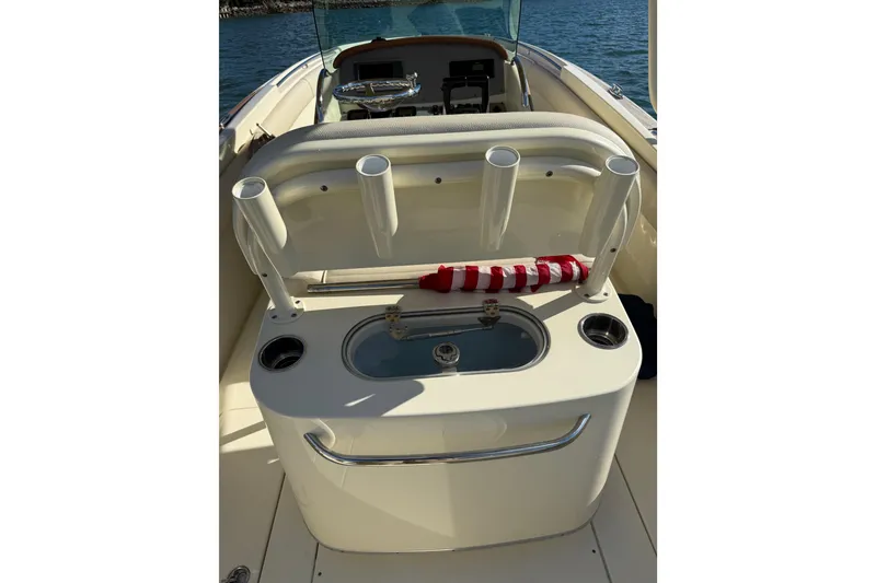 Slide: The Image of 2013 Chris-Craft Catalina 26 boat interior with rod holders and storage compartment. - 11