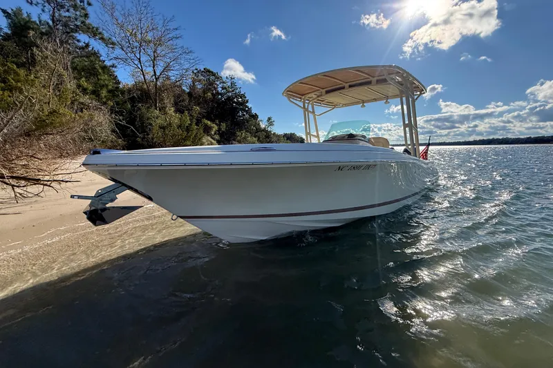 Slide: The Image of 2013 Chris-Craft Catalina 26 boat docked on a sunny beach with clear skies. - 7