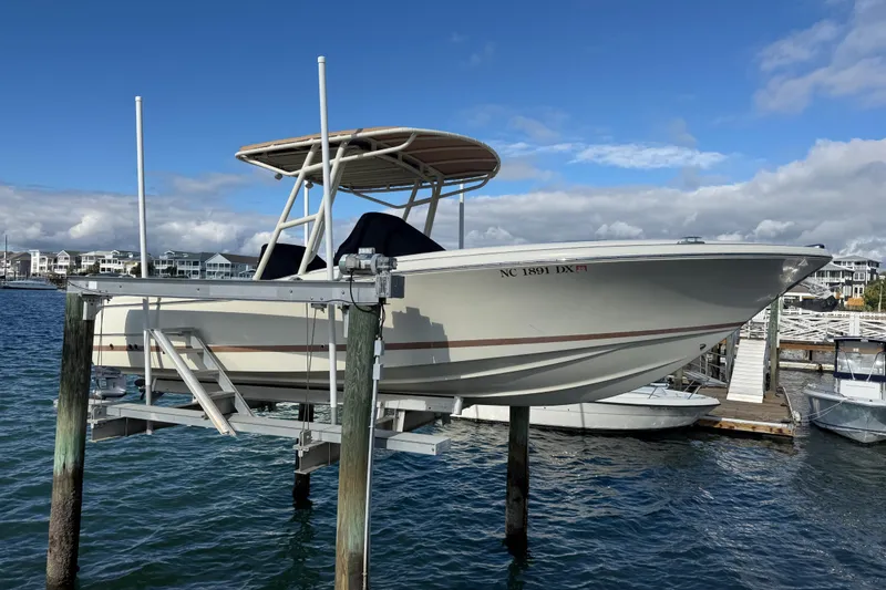 Slide: The Image of 2013 Chris-Craft Catalina 26 boat on lift, dockside with blue sky background. - 9