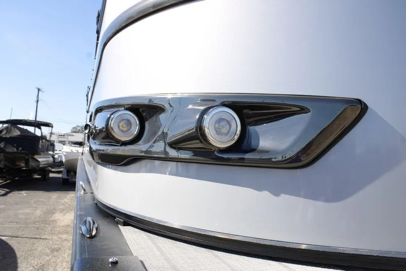 Slide: The Image of 2026 Avalon CATALINA 23 boat with sleek chrome headlights in a marina setting. - 34