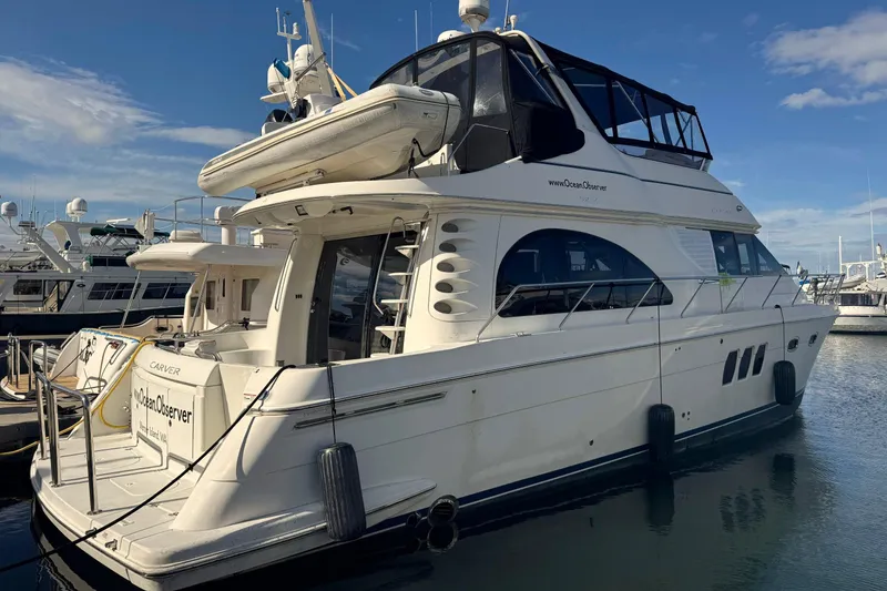 The Image of 2007 Carver 52 Voyager yacht docked at marina under clear blue sky. - 0