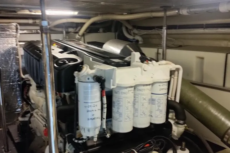 Slide: The Image of Engine room of a 2007 Carver 52 Voyager yacht, showcasing detailed machinery and components. - 12