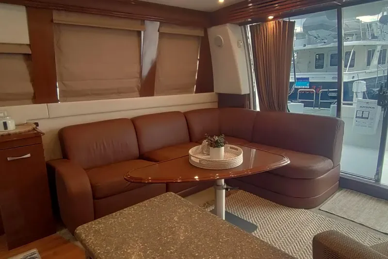 Slide: The Image of Luxurious interior of 2007 Carver 52 Voyager yacht with brown leather seating and elegant decor. - 2