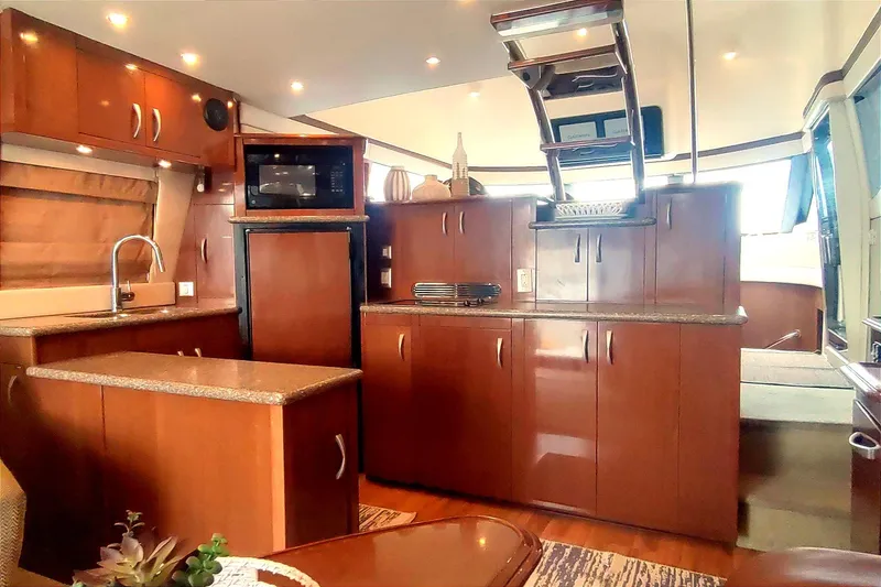 Slide: The Image of Luxurious interior of 2007 Carver 52 Voyager yacht with modern kitchen amenities. - 4