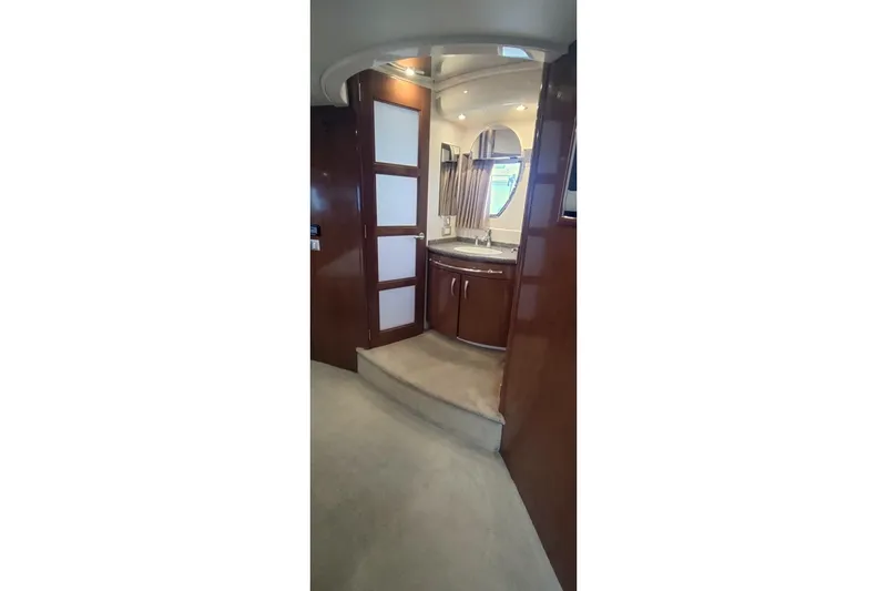 Slide: The Image of Interior of 2007 Carver 52 Voyager yacht, featuring a modern bathroom with wood accents. - 7