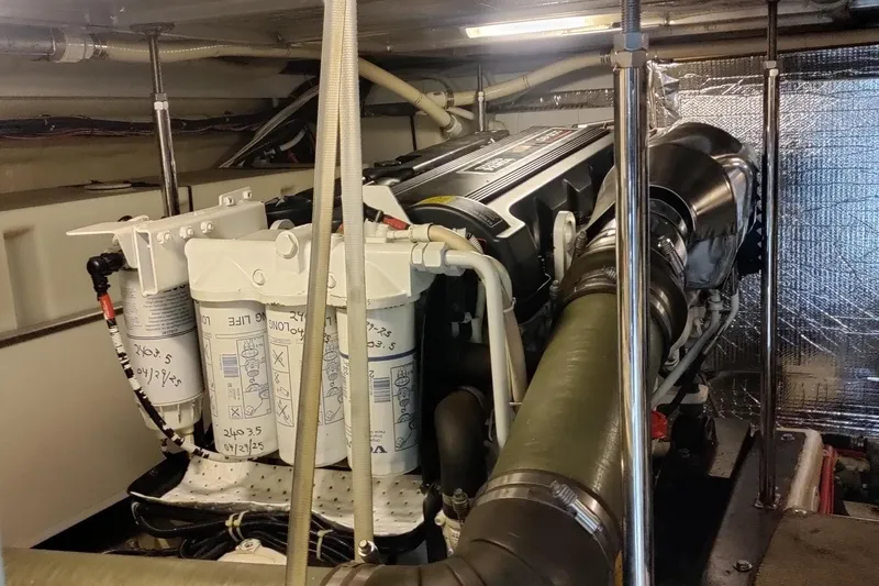 Slide: The Image of Engine room of 2007 Carver 52 Voyager yacht, showcasing detailed mechanical components. - 13