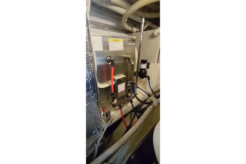 Slide: The Image of Engine room of 2007 Carver 52 Voyager with plumbing and wiring systems. - 16