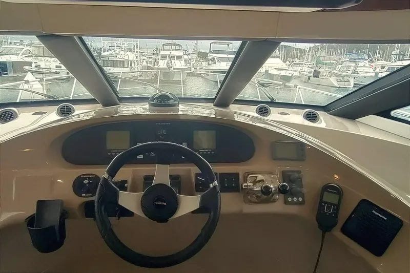 Slide: The Image of Interior helm of 2007 Carver 52 Voyager yacht with steering wheel and navigation controls. - 5