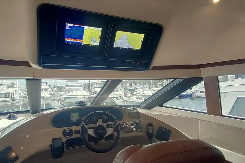 Slide: The Image of Interior helm of 2007 Carver 52 Voyager yacht with navigation screens and steering wheel. - 6