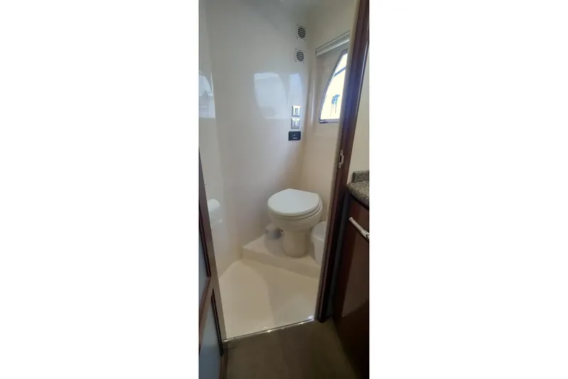 Slide: The Image of 2007 Carver 52 Voyager yacht bathroom with toilet and window. - 8