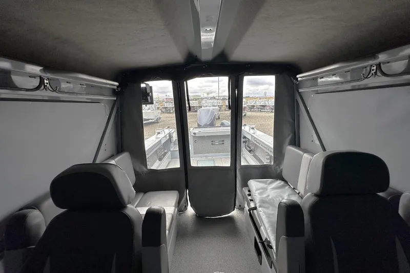 Slide: The Image of Interior of 2023 Hewescraft 240 Ocean Pro ET HT boat, featuring seating and windows. - 10