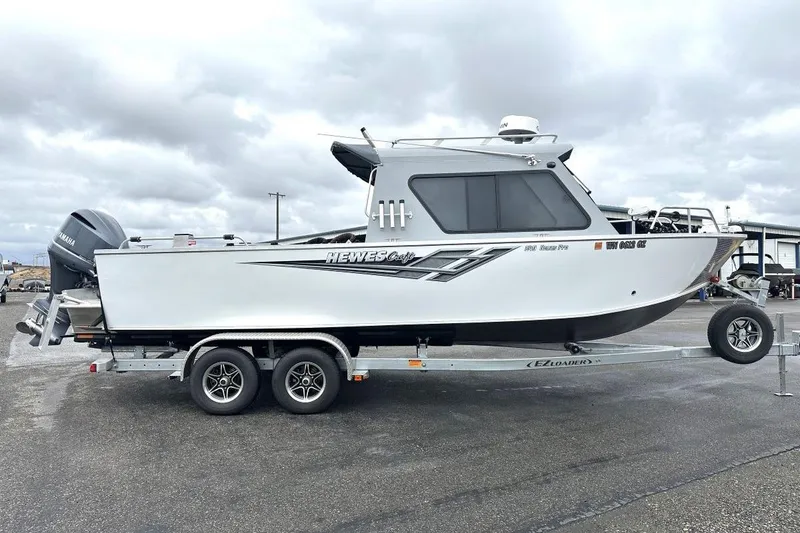 Slide: The Image of 2023 Hewescraft 240 Ocean Pro ET HT boat on trailer, parked outdoors. - 3