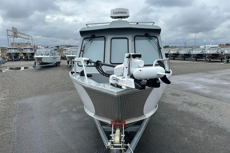 Slide: The Image of 2023 Hewescraft 240 Ocean Pro ET HT boat with Garmin equipment, parked on a cloudy day. - 4