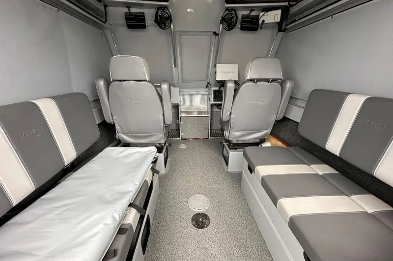 Slide: The Image of 2023 Hewescraft 240 Ocean Pro ET HT interior with gray seating and Garmin equipment. - 6