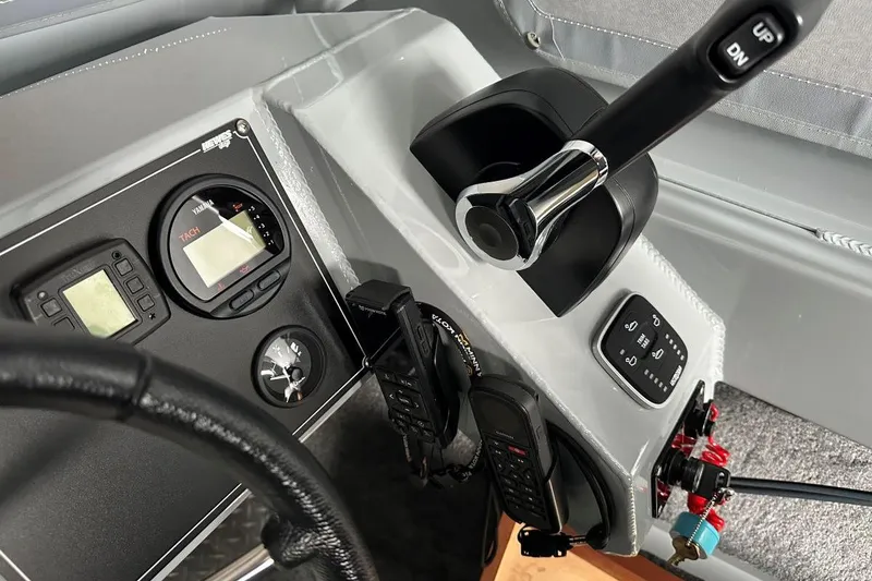 Slide: The Image of Control panel of 2023 Hewescraft 240 Ocean Pro ET HT boat with throttle and gauges. - 9