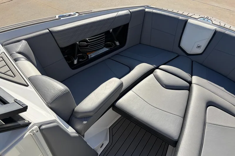 Slide: The Image of 2020 Nautique Super Air Nautique G23 interior with gray seating and cup holders. - 16