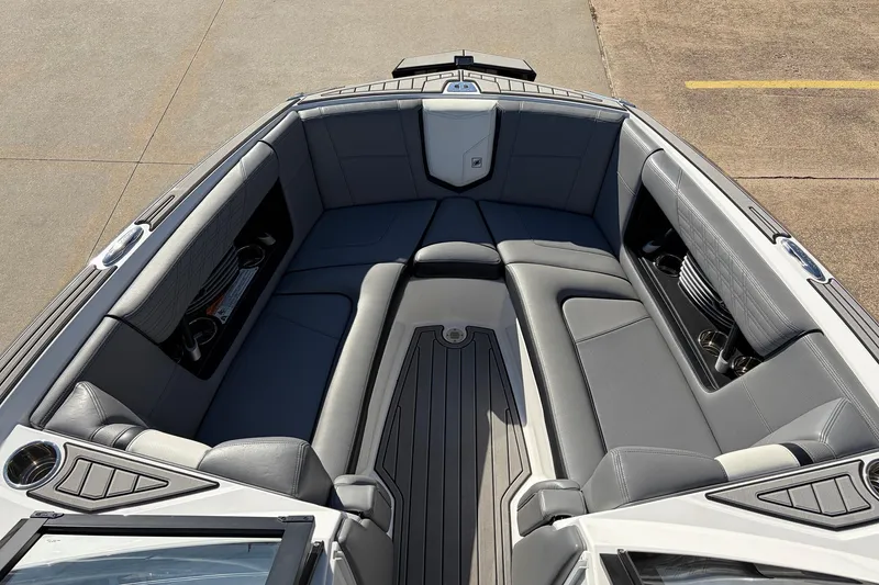 Slide: The Image of 2020 Nautique Super Air Nautique G23 boat interior with gray seating and cup holders. - 19
