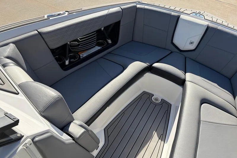 Slide: The Image of 2020 Nautique Super Air Nautique G23 boat interior with gray seating and cup holders. - 20
