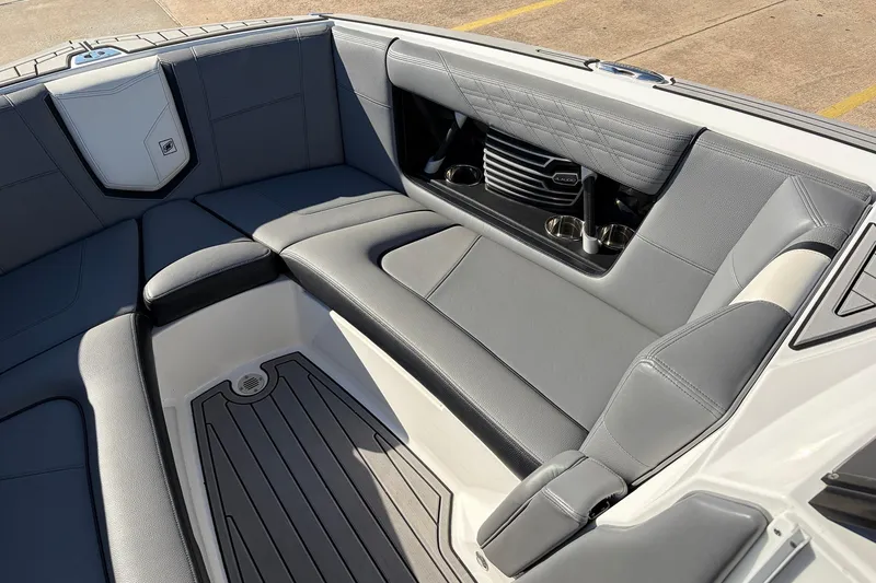 Slide: The Image of 2020 Nautique Super Air Nautique G23 boat interior with gray seating and cup holders. - 21