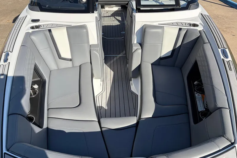 Slide: The Image of 2020 Nautique Super Air Nautique G23 boat interior with gray seating and cup holders. - 22
