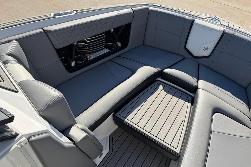 Slide: The Image of 2020 Nautique Super Air Nautique G23 boat interior with gray seating and cup holders. - 24