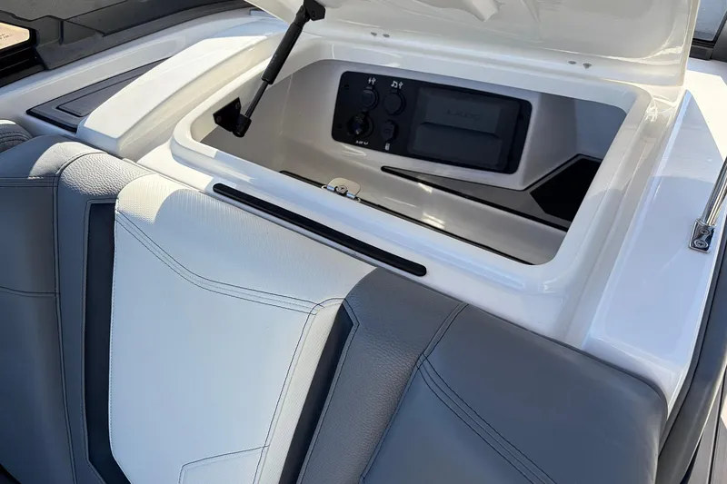 Slide: The Image of 2020 Nautique Super Air Nautique G23 boat interior with open storage compartment. - 27