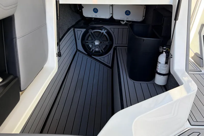 Slide: The Image of 2020 Nautique Super Air Nautique G23 interior storage with speaker and fire extinguisher. - 29