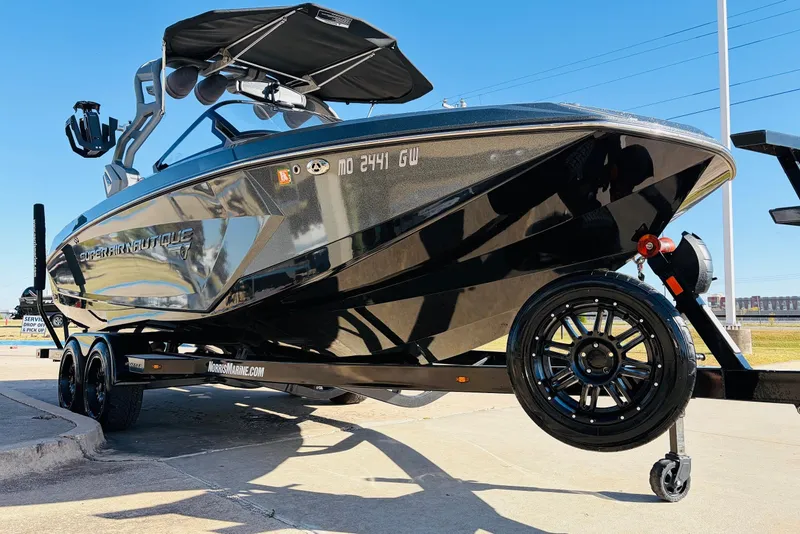 Slide: The Image of 2020 Nautique Super Air Nautique G23 boat on trailer, sleek design, sunny day. - 3