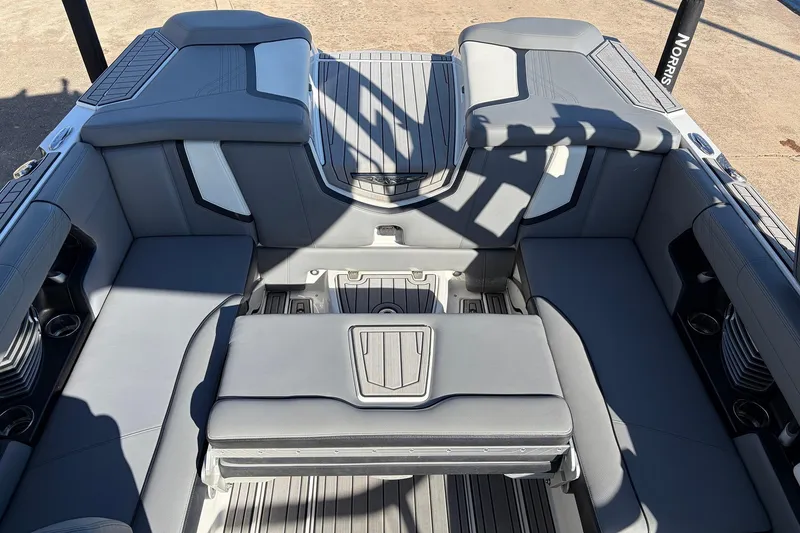 Slide: The Image of 2020 Nautique Super Air Nautique G23 interior with gray seating and cup holders. - 34