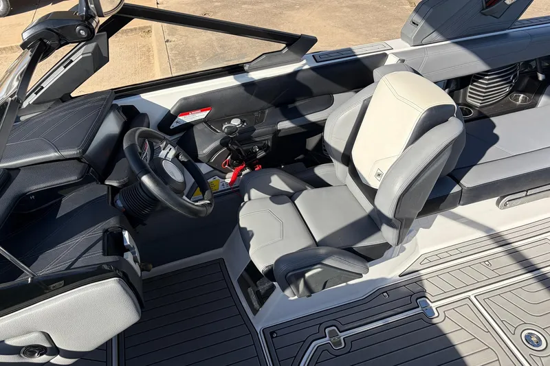 Slide: The Image of 2020 Nautique Super Air Nautique G23 interior with steering wheel and seating. - 43