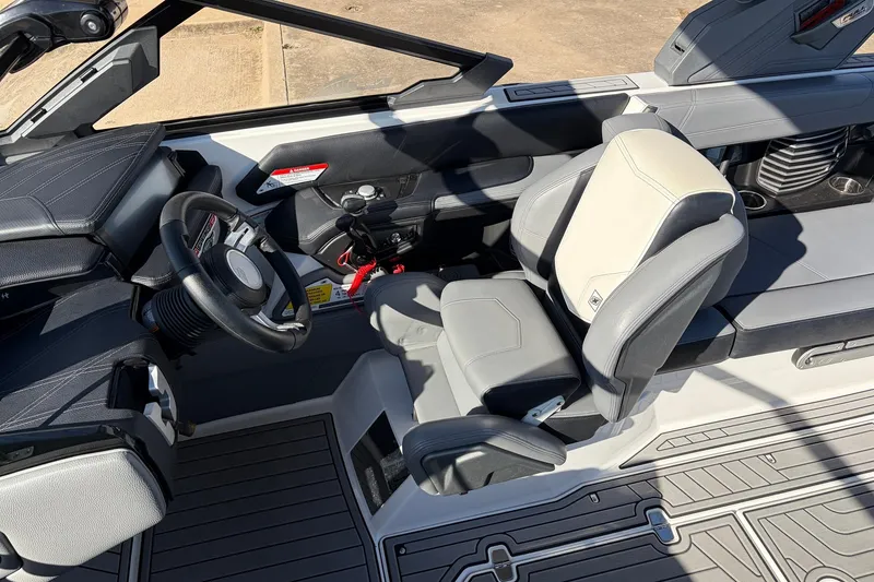 Slide: The Image of 2020 Nautique Super Air Nautique G23 boat interior with steering wheel and seating. - 44