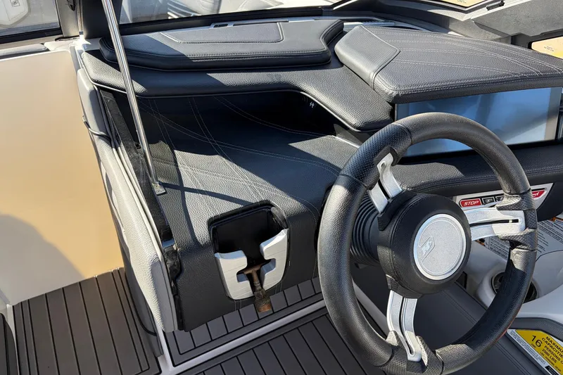Slide: The Image of 2020 Nautique Super Air Nautique G23 boat interior with steering wheel and dashboard. - 46