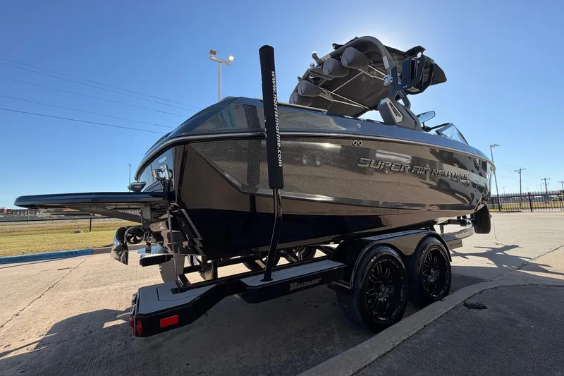 Slide: The Image of 2020 Nautique Super Air Nautique G23 boat on trailer under clear blue sky. - 5