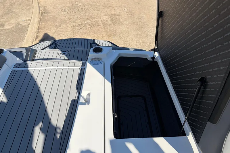Slide: The Image of 2020 Nautique Super Air Nautique G23 boat storage compartment with open hatch. - 52