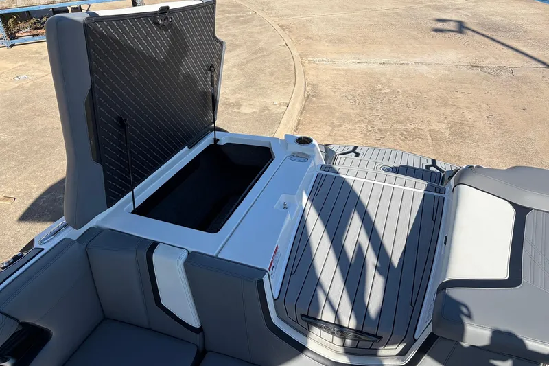 Slide: The Image of 2020 Nautique Super Air Nautique G23 boat with open storage compartment. - 53