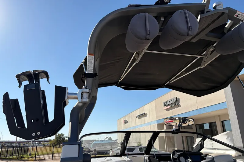 Slide: The Image of 2020 Nautique Super Air Nautique G23 boat with wakeboard rack and bimini top. - 59