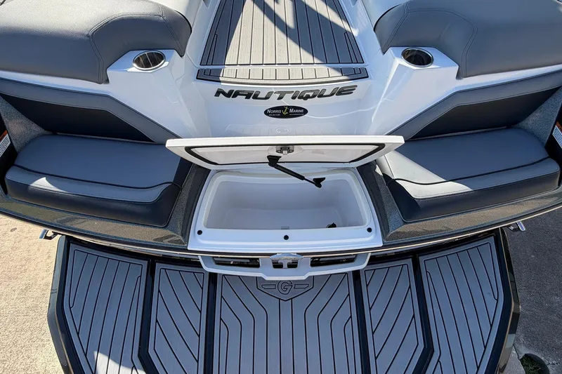 Slide: The Image of 2020 Nautique Super Air Nautique G23 boat with open storage compartment and cushioned seating. - 66