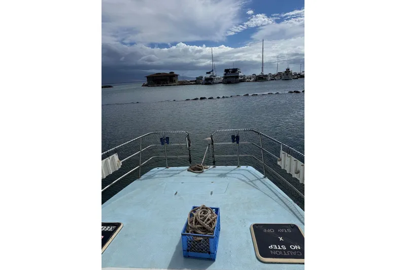 Slide: The Image of Douglas Phillips 1998 Power Cat boat deck with marina view and cloudy sky. - 4