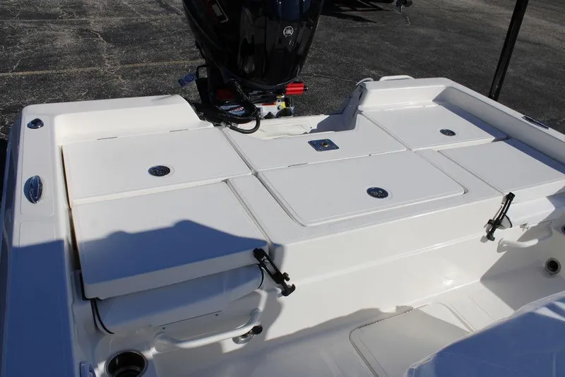 Slide: The Image of 2026 Skeeter SX230 boat deck with storage compartments and motor. - 11