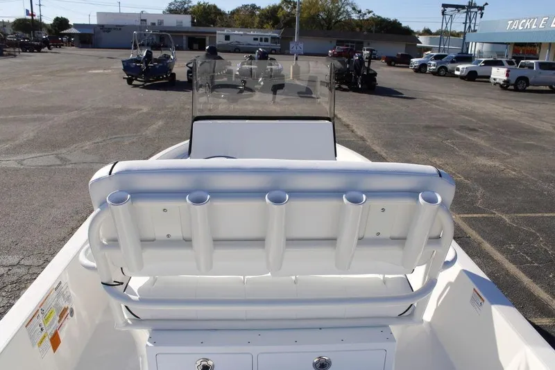 Slide: The Image of 2026 Skeeter SX230 boat with rod holders, parked in a dealership lot. - 14
