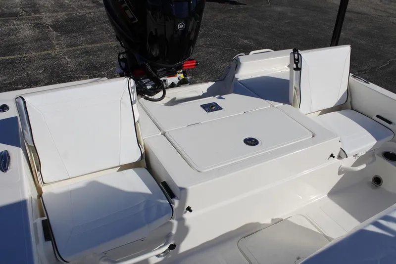 Slide: The Image of 2026 Skeeter SX230 boat interior with white seating and motor, showcasing modern design. - 15