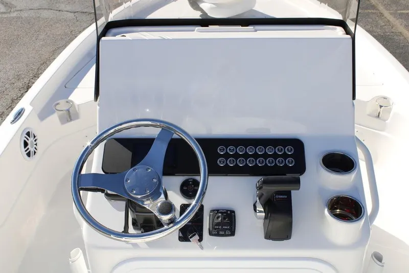 Slide: The Image of 2026 Skeeter SX230 boat console with steering wheel and controls. - 20