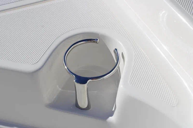 Slide: The Image of 2026 Skeeter SX230 boat detail with chrome rod holder on textured white surface. - 22