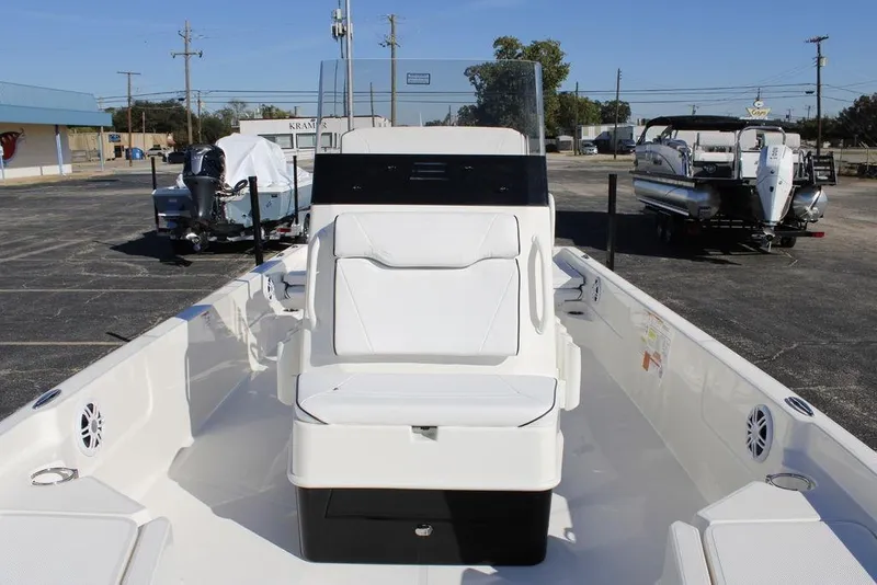 Slide: The Image of 2026 Skeeter SX230 boat with white seating and console in a parking lot. - 26