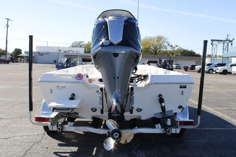 Slide: The Image of 2026 Skeeter SX230 boat with powerful outboard motor in a parking lot. - 3