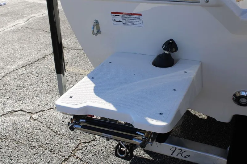 Slide: The Image of 2026 Skeeter SX230 boat swim platform with ladder on asphalt surface. - 7