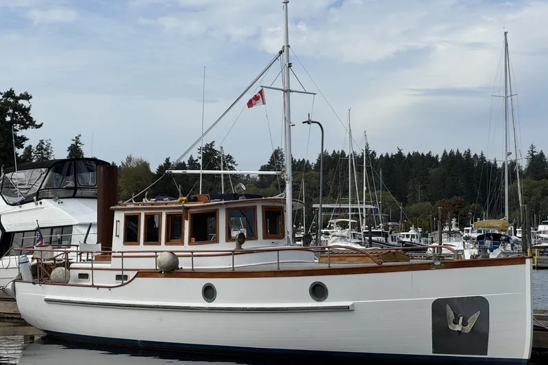 The Image of 1987 Liberty Gatsby boat docked in a marina with Canadian flag. - 0