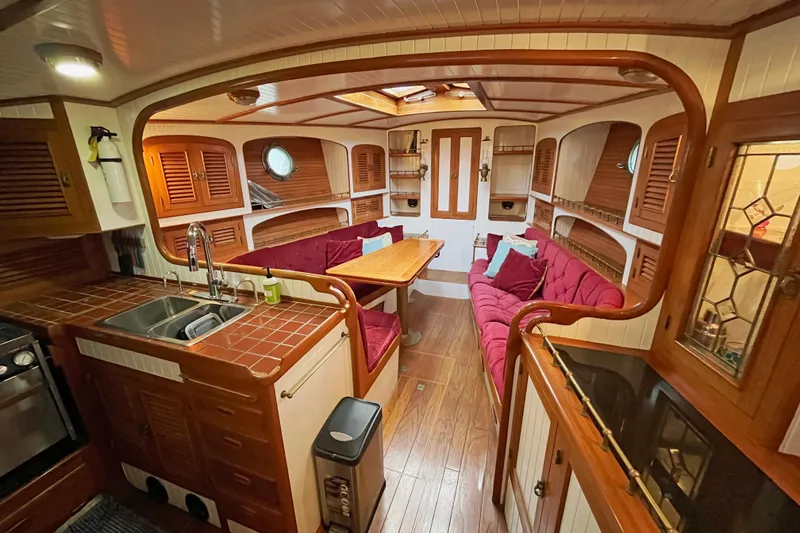 Slide: The Image of Luxurious 1987 Liberty Gatsby yacht interior with wood accents and plush seating. - 1